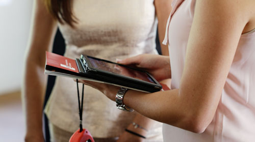 2 ladies using a tracking system on a tablet